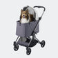 Dog sitting up in a gray pet stroller made by Ibiyaya Maxi