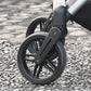 Close-up of a Ibiyaya Maxi pet stroller wheel on a pebbled surface