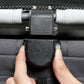 Close-up of a hand adjusting the clip on the canopy of the Ibiyaya Maxi pet stroller