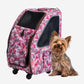 Terrier sitting next to Petique 5-in-1 detachable pet carrier featured in pink camo.