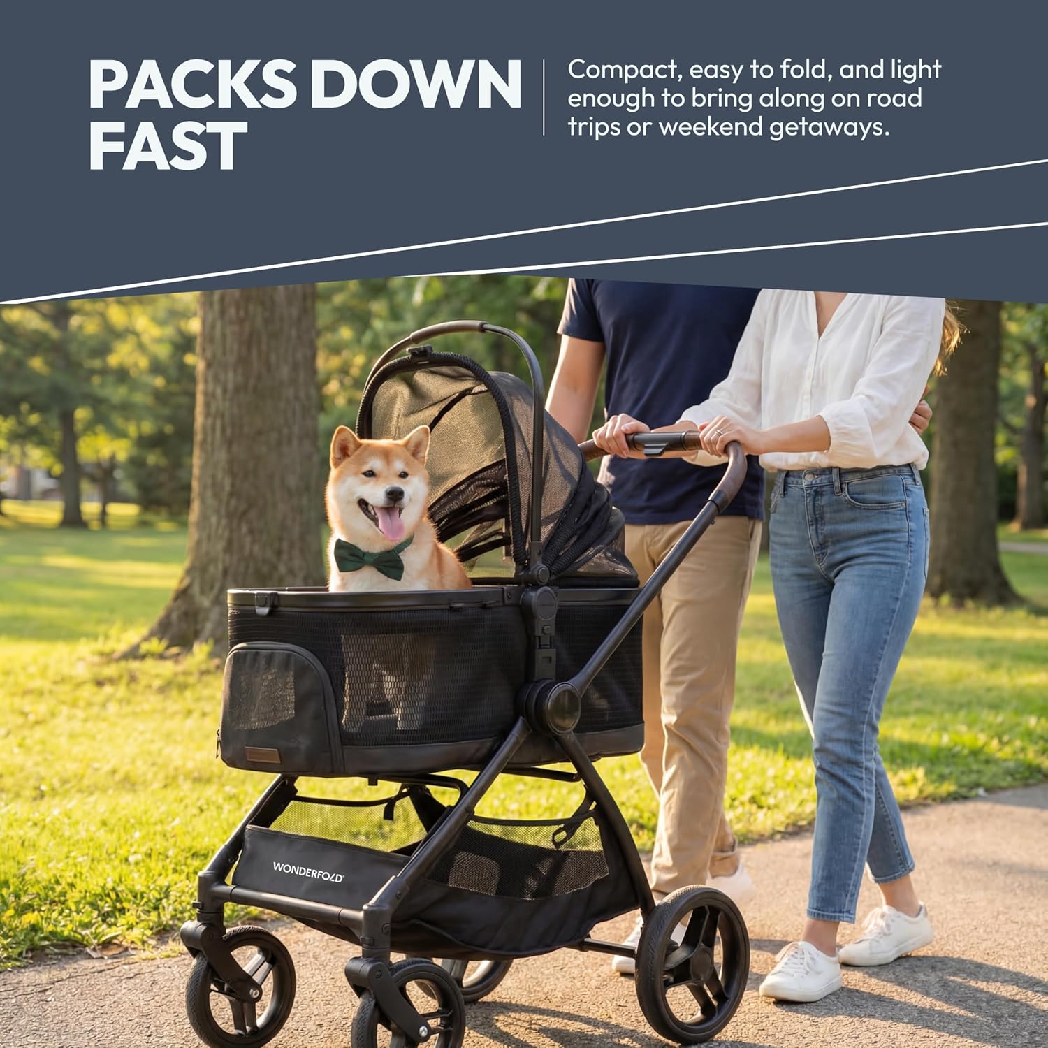 Couple walking Shiba Inu dog in WonderFold Buddy pet stroller at park — lightweight foldable dog stroller
