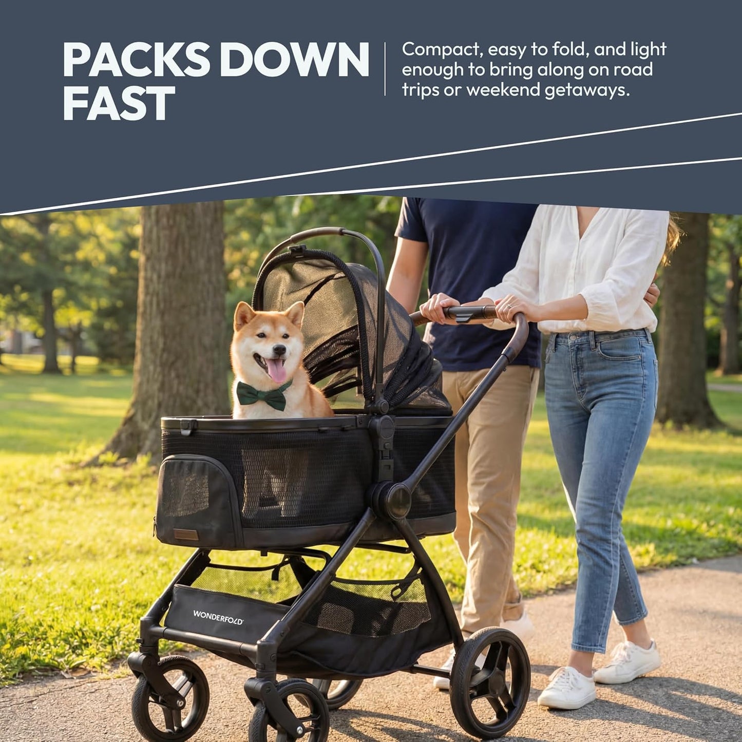 Couple walking Shiba Inu dog in WonderFold Buddy pet stroller at park — lightweight foldable dog stroller